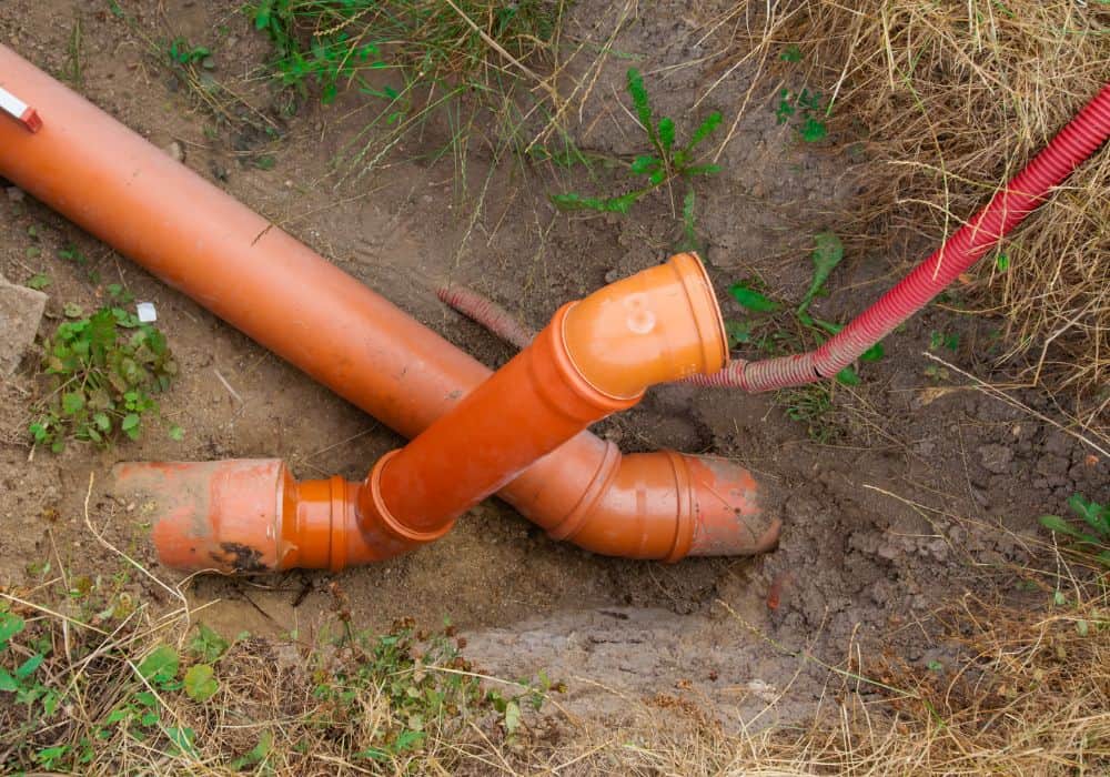 What are the steps in installing a sewer drain pipe